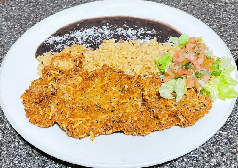 Chicken milanese plato served with rice, beans, and fresh salad at M.C. Luncheonette