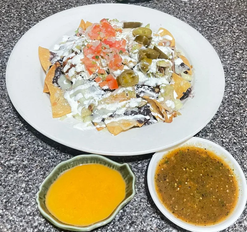 Loaded nachos with fresh toppings and salsas