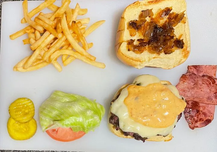 Signature burger with fries served at M.C. Luncheonette
